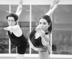 Two Ladies in Bikram Yoga Bow Pose Sweating