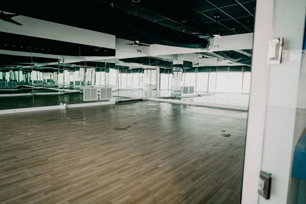 View of the empty YogaSol Heated Studio with mirrors on all walls