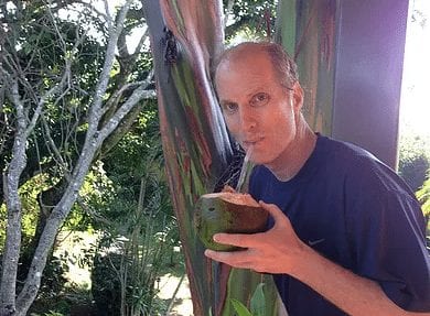 Founder of YogaSol Dan Markowitz sipping a coconut outside the Pura Vida Spa at the yoga retreat in Costa Rica