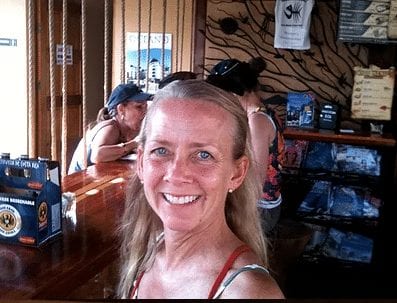 Smiling yogini in pura vida spa gift shop at yoga retreat in costa rica