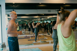 hot yoga participants practice pranayama inhale