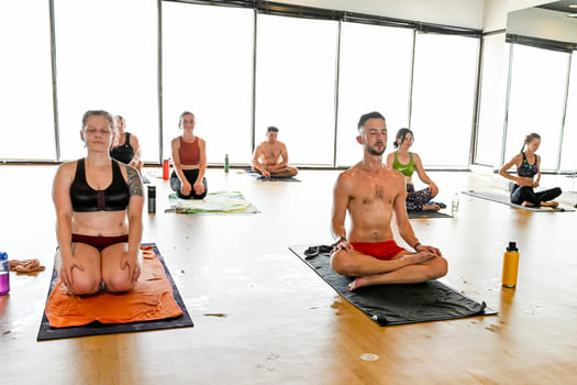 hot yoga community sitting in asana